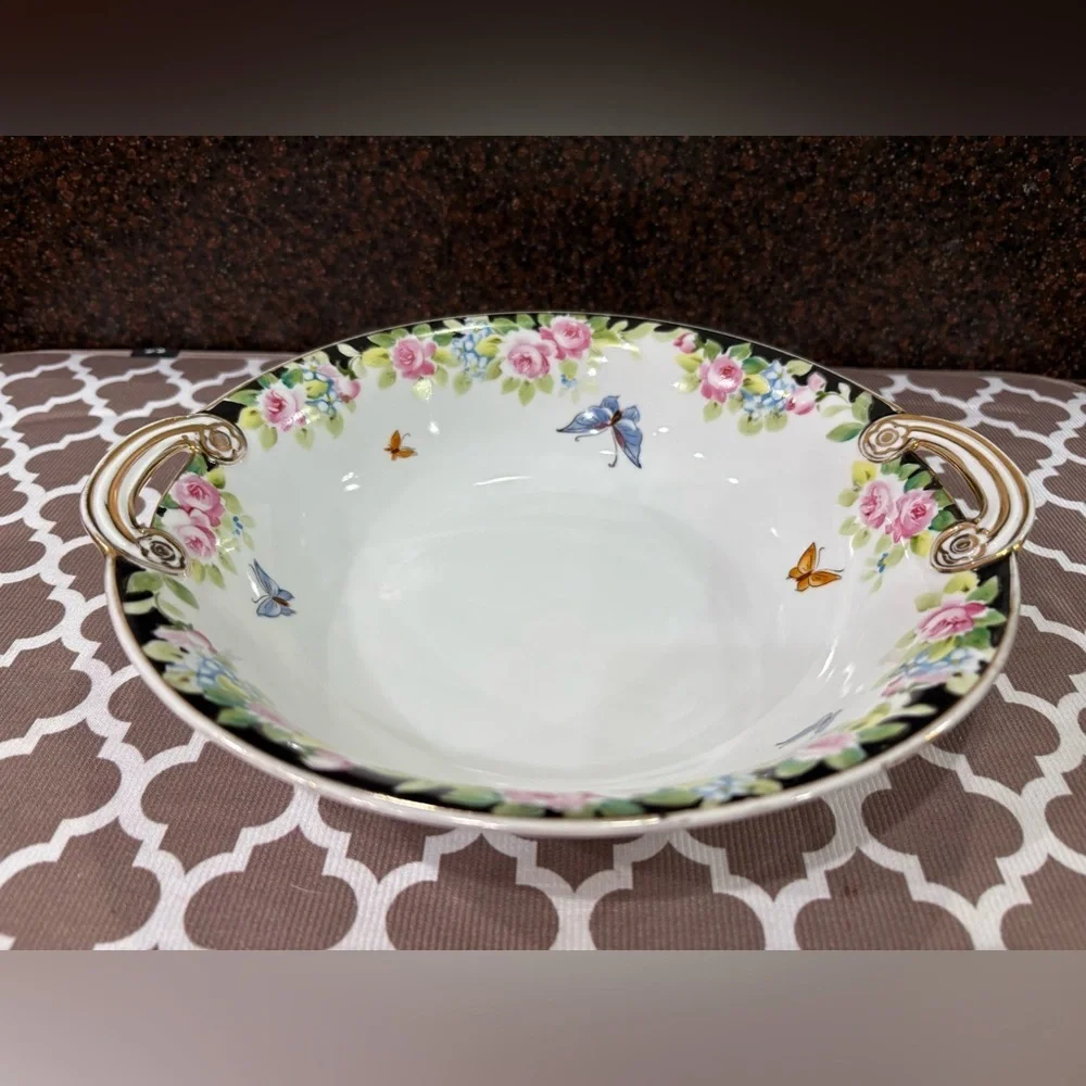 Nippon Hand-painted bowl featuring a floral motif & butterflies with gold trim